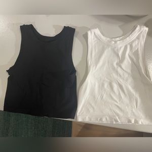 TWO free people intimately seamless crop muscle tank.  XS/S black and white.